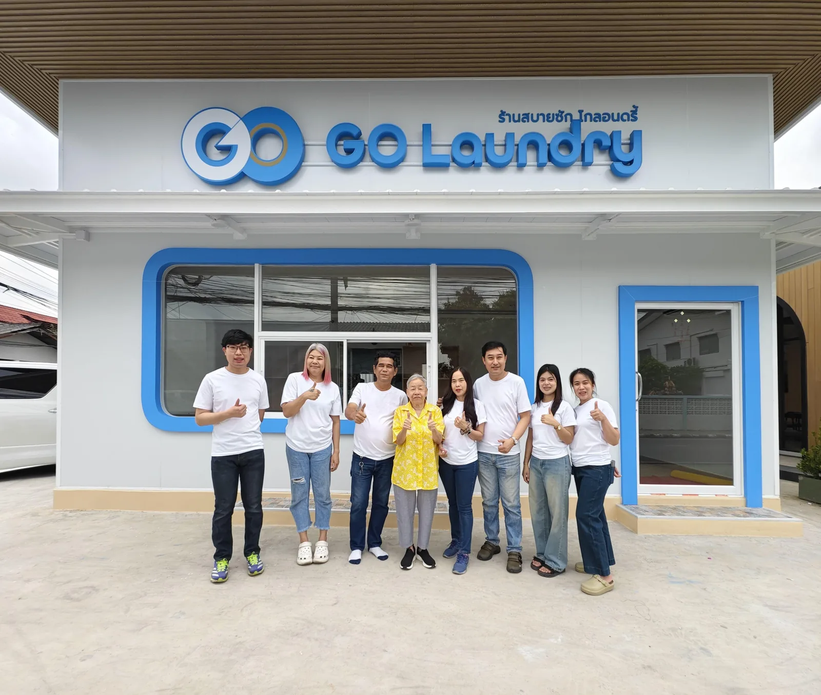 The GO Laundry team outside one of the Bangkok branches