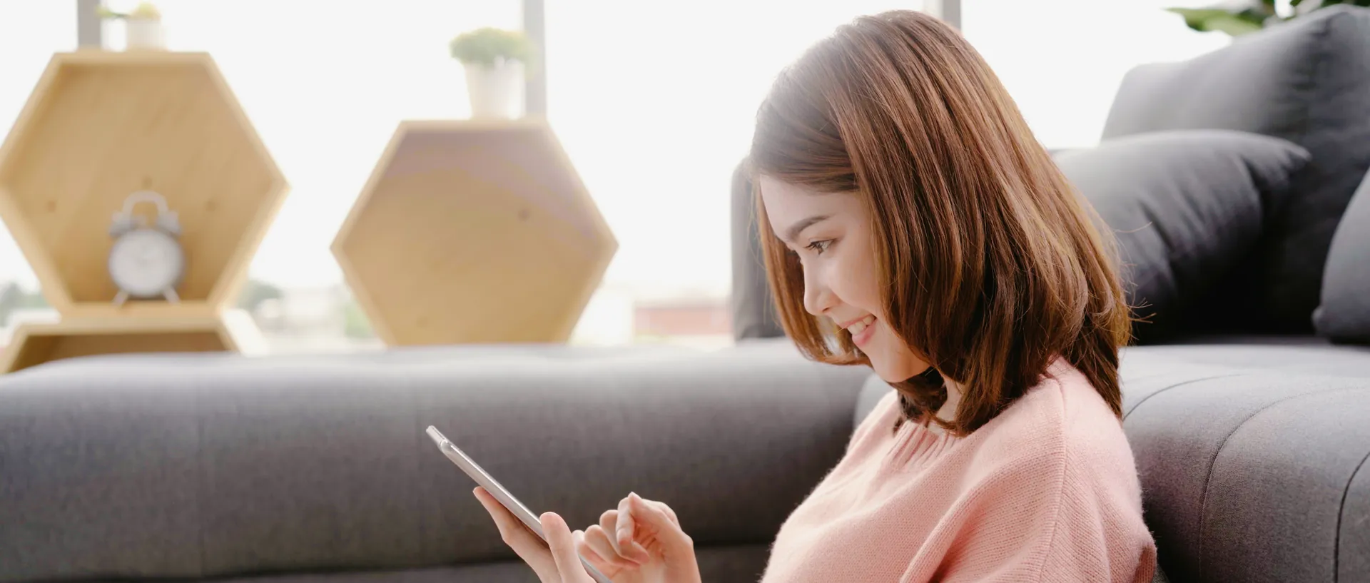 A guest relaxing at home with a tablet, laundry off her list