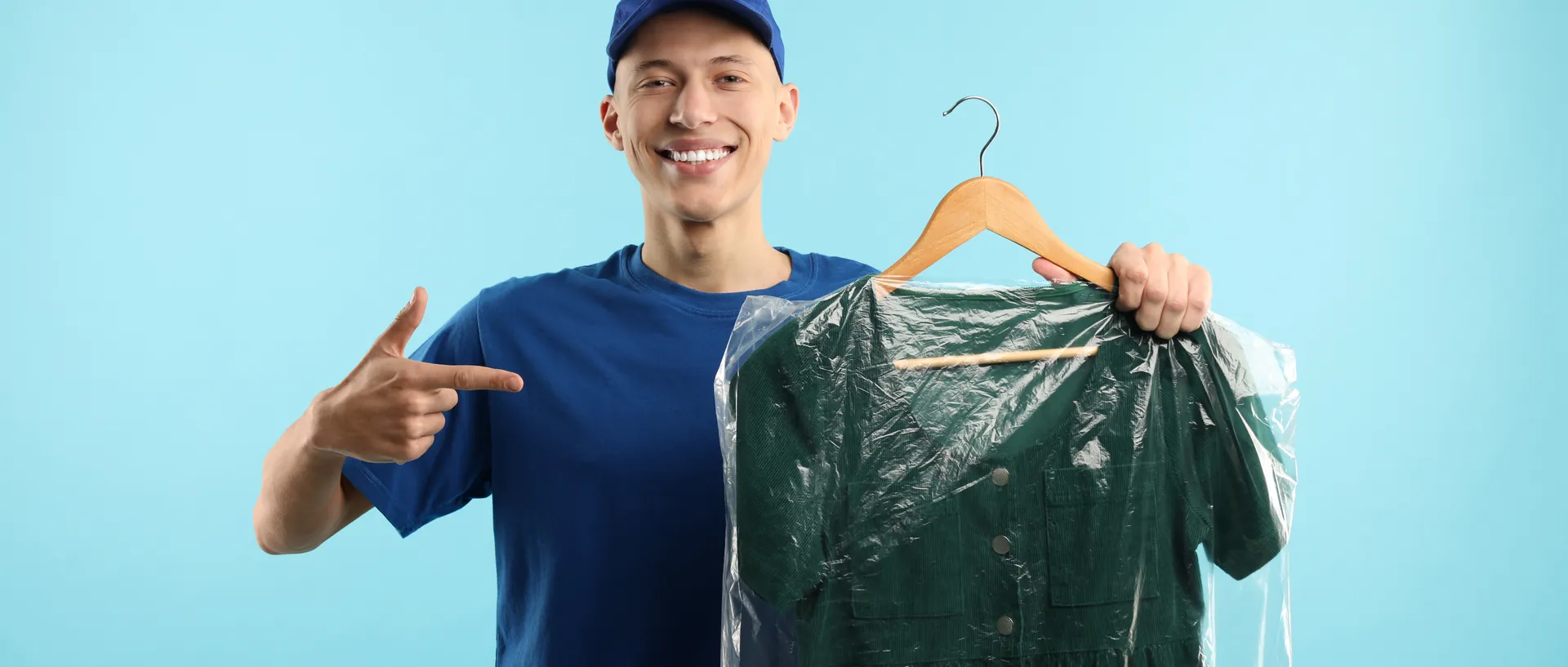 A courier carrying a garment bag back to a guest